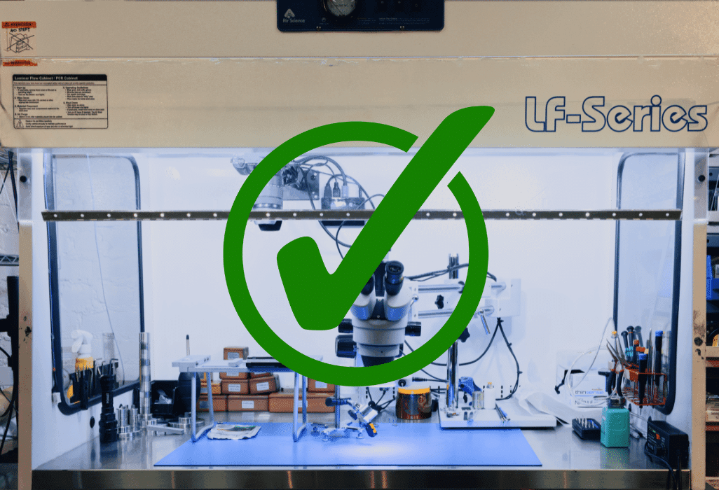 Laminar‑flow bench with a large green checkmark